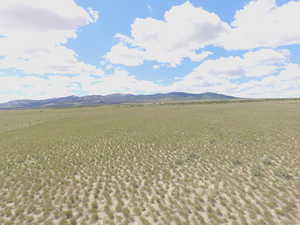 View of mountain backdrop with rural landscape
