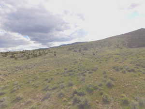 View of mountain backdrop featuring rural landscape