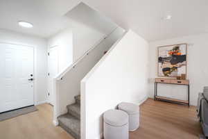 Foyer featuring stairway and light wood-style flooring