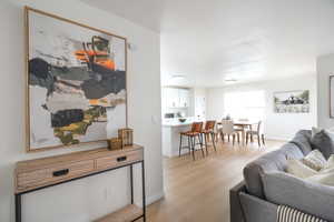 Living area with light wood finished floors and baseboards