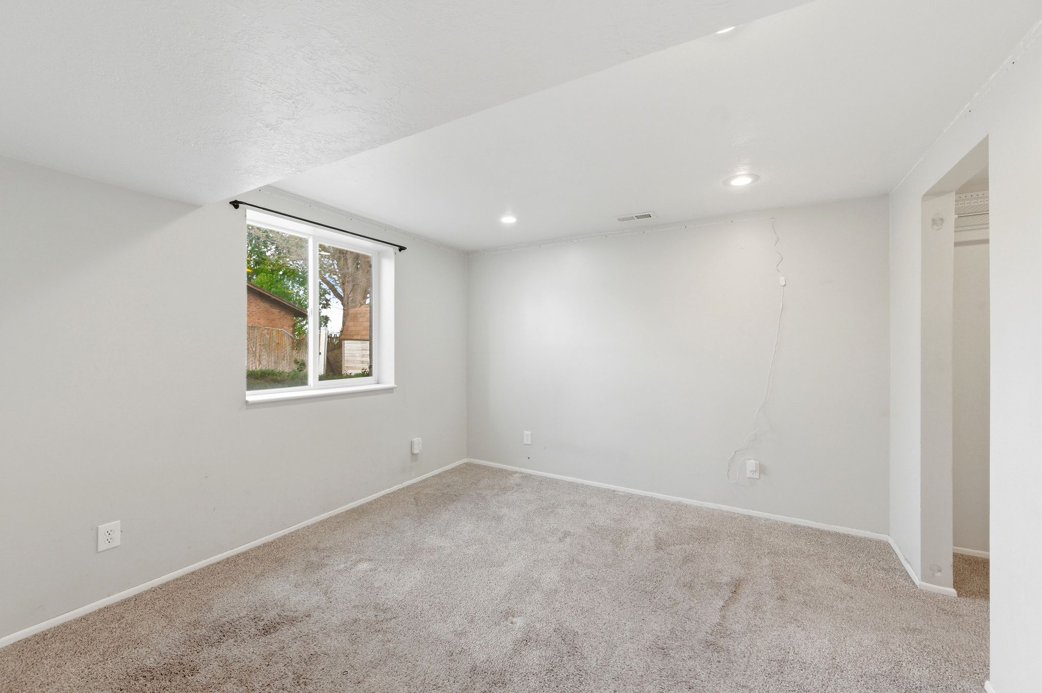Spare room featuring carpet floors and recessed lighting