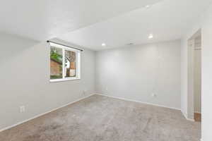 Spare room featuring carpet floors and recessed lighting