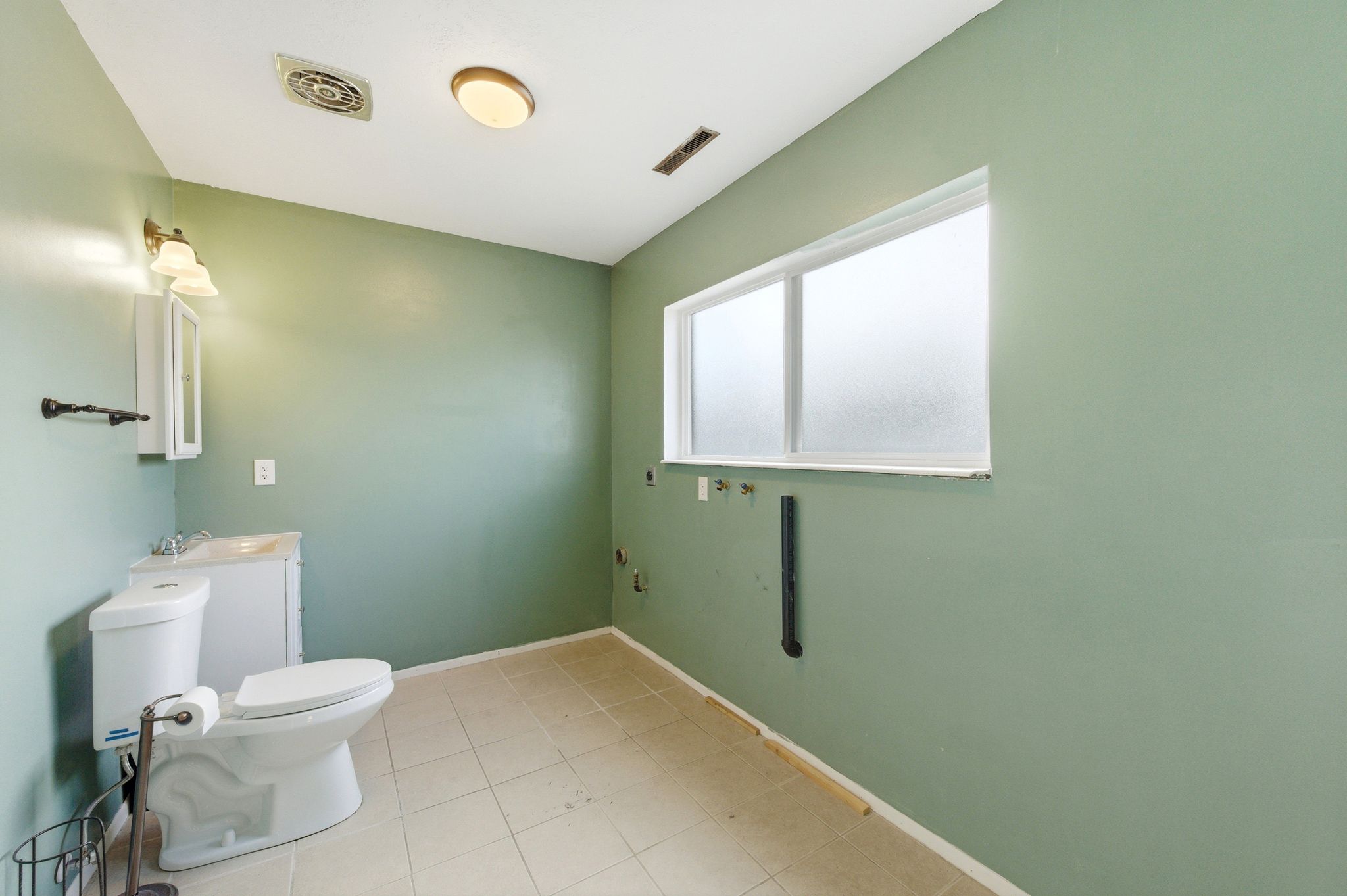 Half bathroom featuring toilet and vanity