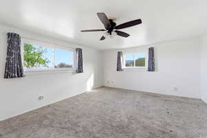 Unfurnished room with carpet flooring and a ceiling fan