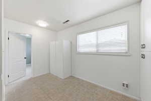 Unfurnished bedroom with baseboards