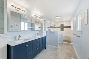 Bathroom featuring double vanity and a walk in shower
