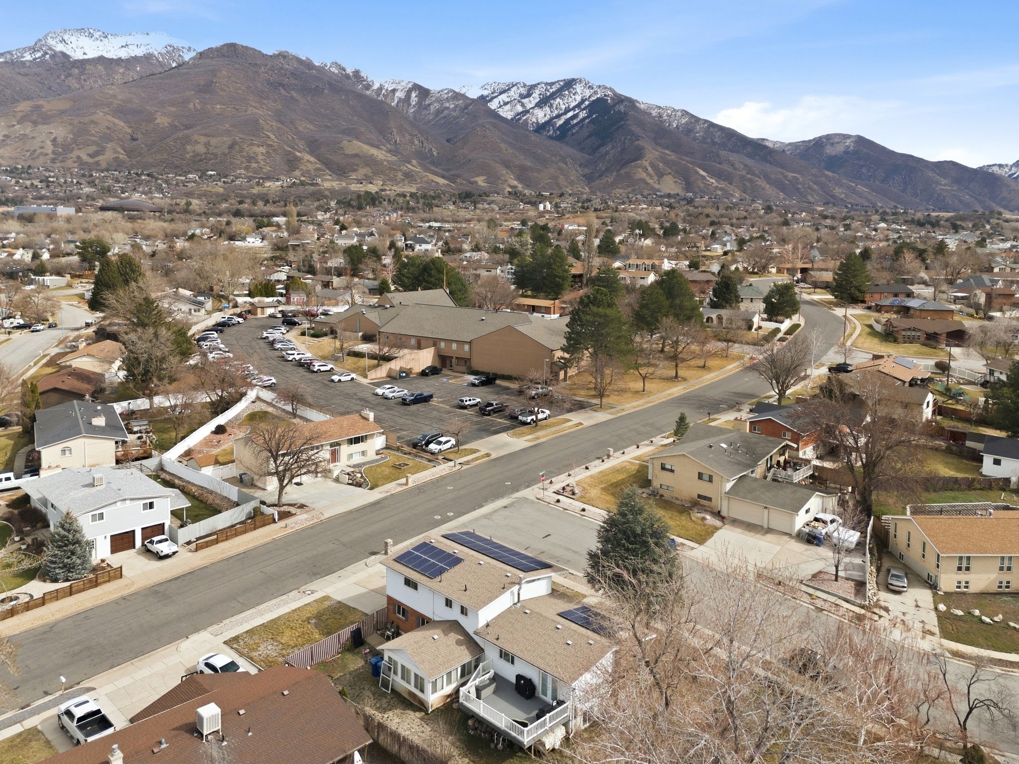 Aerial overview of property's location with nearby suburban area and mountains