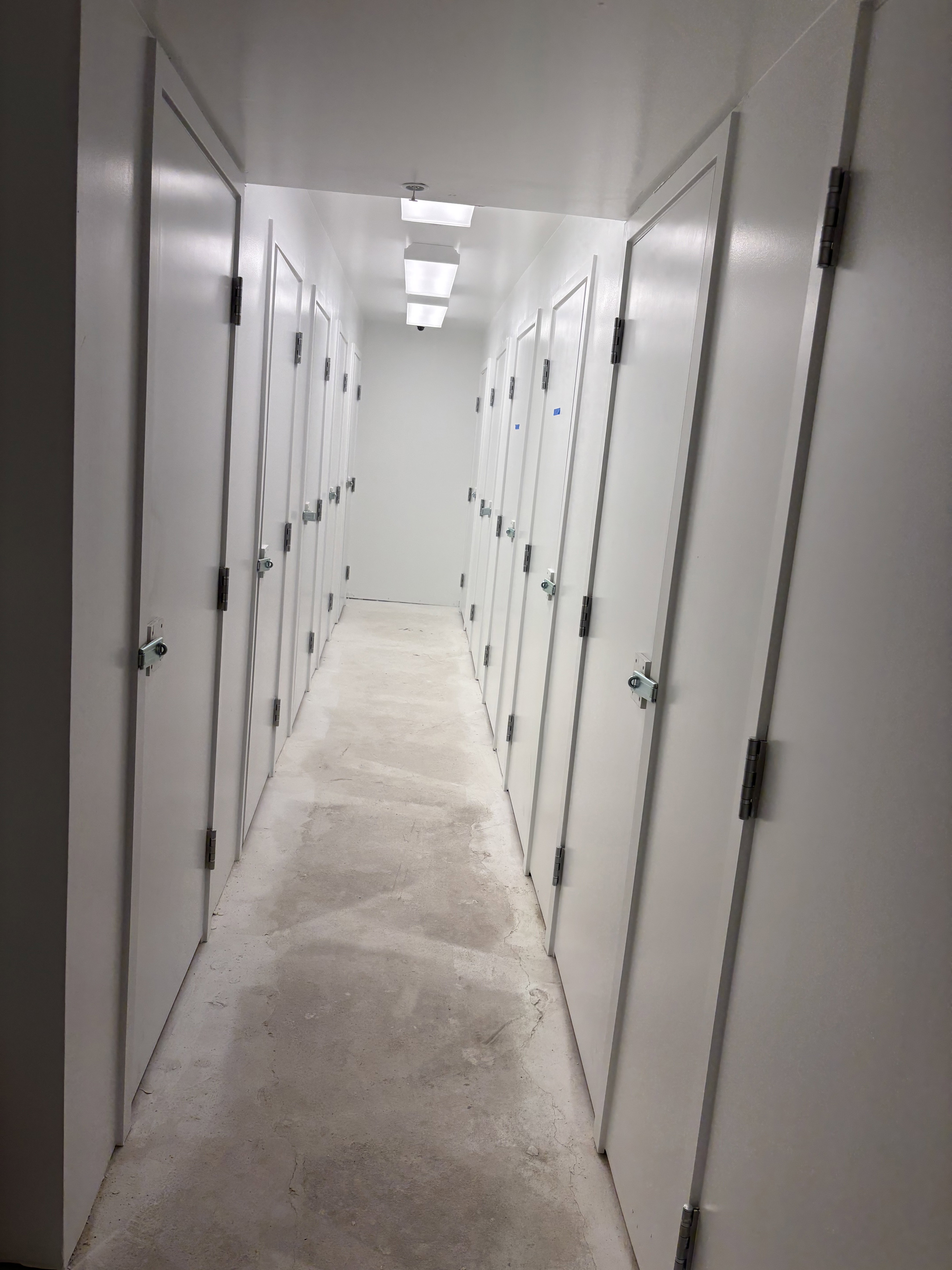 Corridor featuring concrete flooring