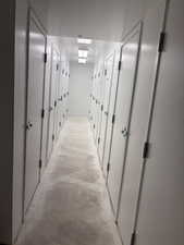 Corridor featuring concrete flooring