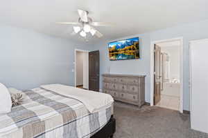 Bedroom featuring carpet, ceiling fan, and connected bathroom