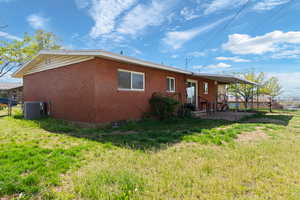 Back of property with a patio area and brick siding