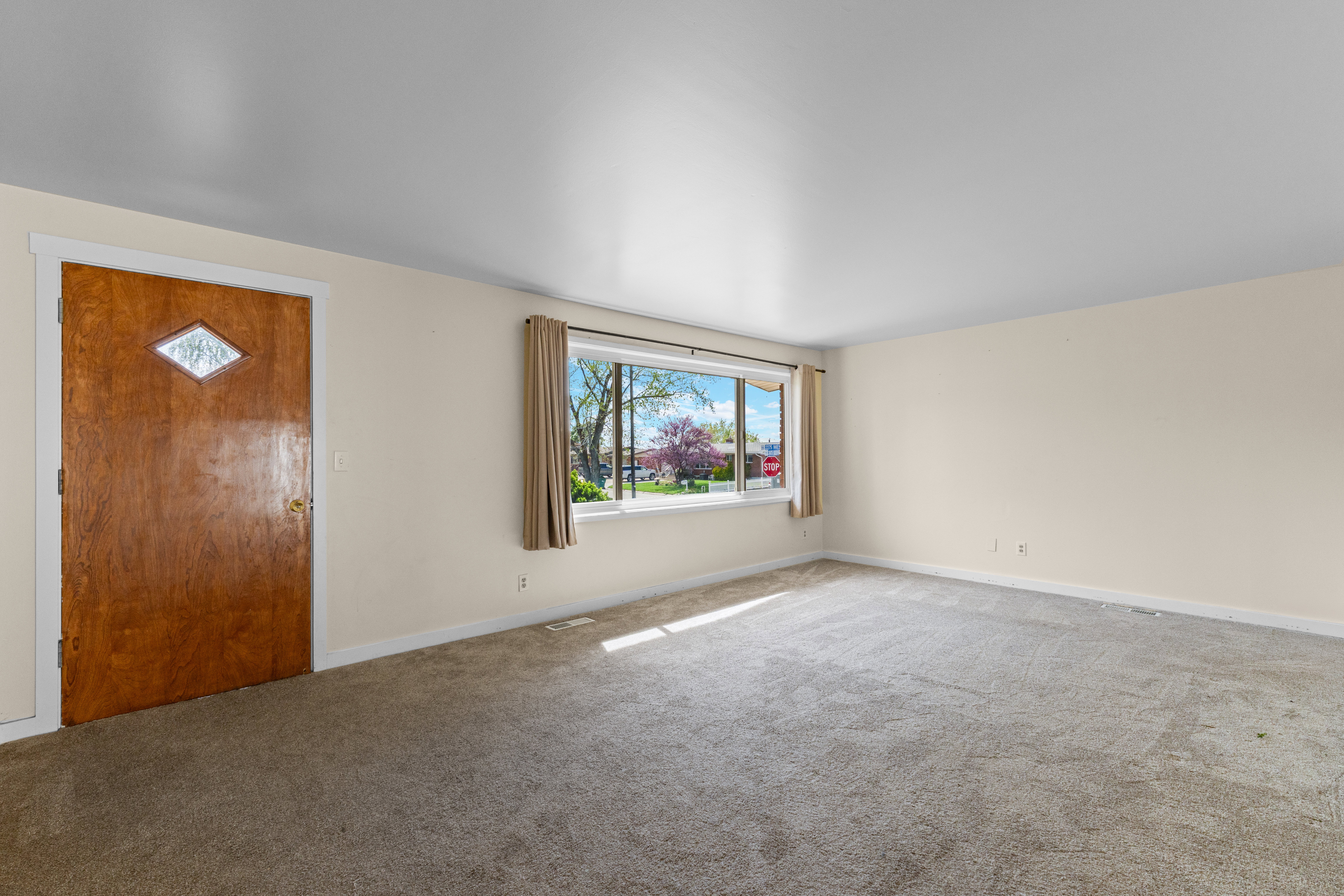 Foyer entrance with carpet flooring and baseboards