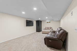 Living room featuring light carpet and recessed lighting