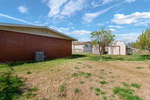 View of yard featuring a storage unit