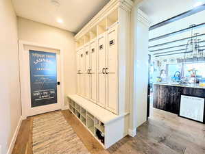 Mudroom featuring light wood finished floors and recessed lighting