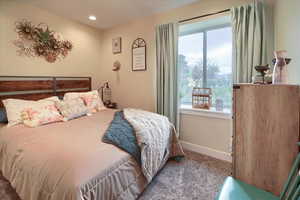 Carpeted bedroom with baseboards and recessed lighting
