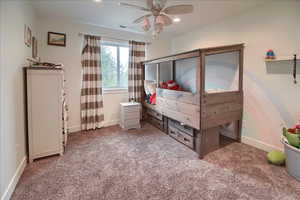 Carpeted bedroom with ceiling fan and recessed lighting