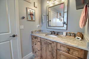 Bathroom featuring vanity and baseboards