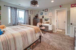 Carpeted bedroom featuring recessed lighting and baseboards
