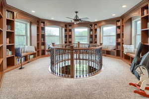 Office area featuring built in shelves, carpet, ceiling fan, and recessed lighting