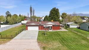 View of front of home featuring concrete driveway, a garage, brick siding, a residential view, and a chimney