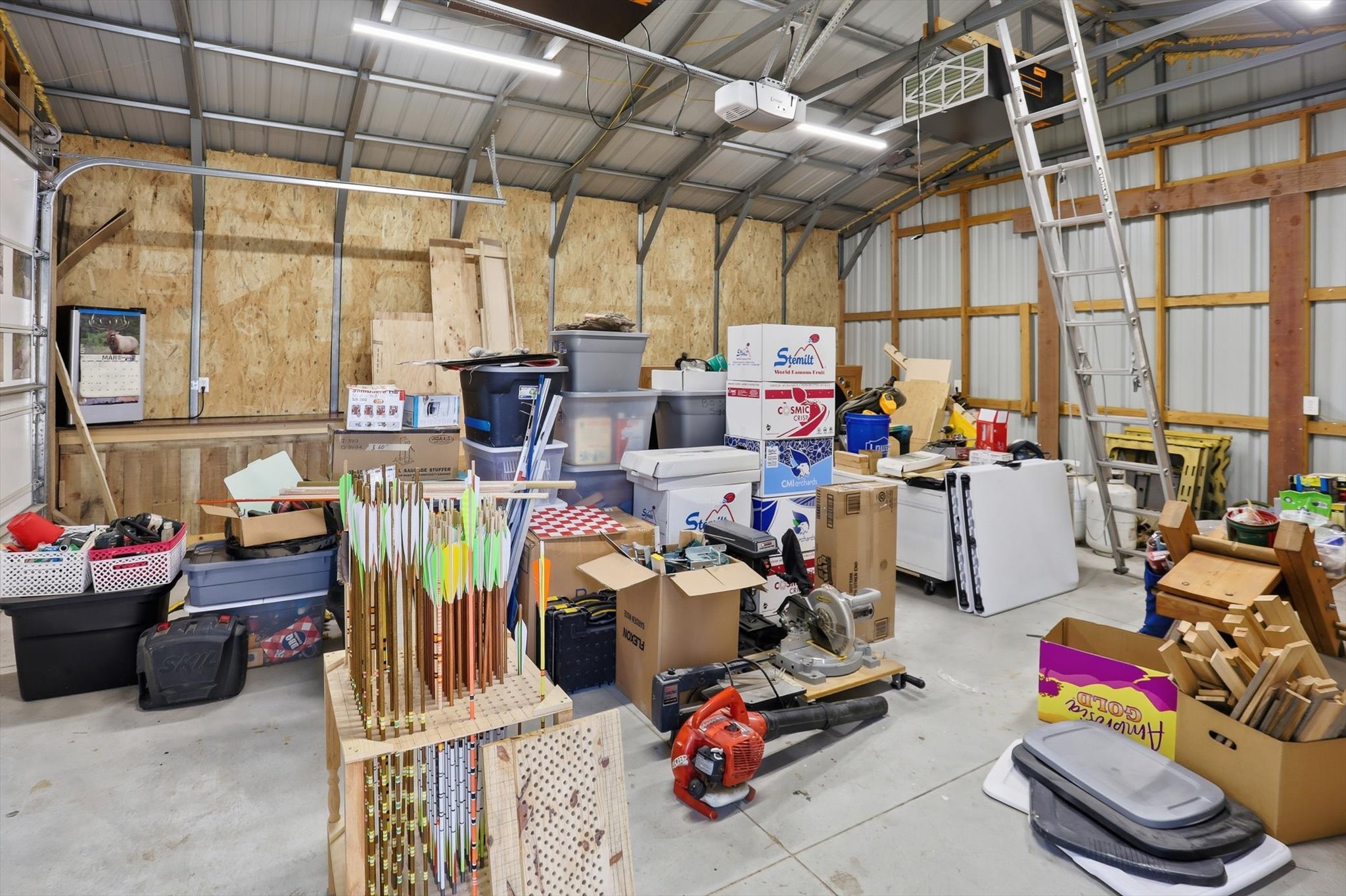 Garage with a garage door opener and metal wall