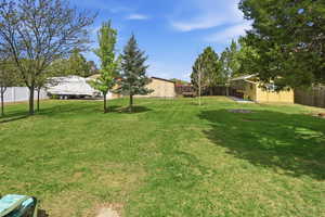 Fenced backyard with a storage shed
