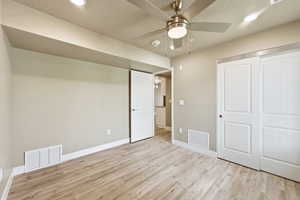 Unfurnished bedroom featuring recessed lighting, light wood-style floors, ceiling fan, a textured ceiling, and a closet