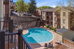 Community pool featuring large lounging area