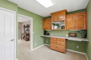 Versatile laundry room includes sink (not pictured), cabinetry, and counter space. View from washer and dryer space.