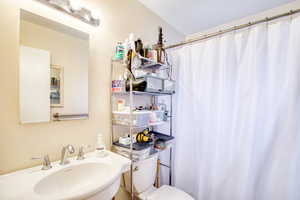 Full bath with toilet and curtained shower