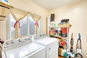 Laundry room with washer and clothes dryer