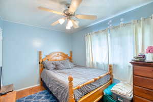 Bedroom featuring ceiling fan and wood finished floors
