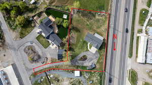 Aerial view of property and surrounding area featuring property parcel outlined