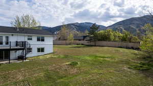 Fenced yard with a patio area and a mountain view
