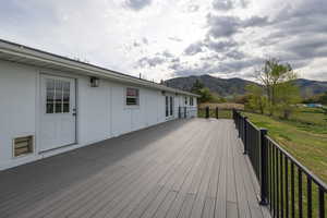 Deck featuring a yard and a mountain view