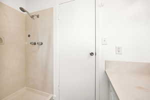 Bathroom featuring a shower stall and vanity