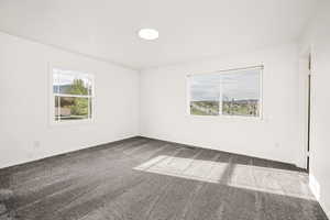 Empty room featuring carpet flooring and baseboards