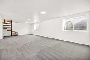 Basement with stairs and carpet floors