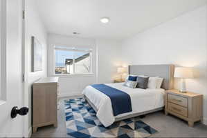 Bedroom 2 with baseboards and light carpet