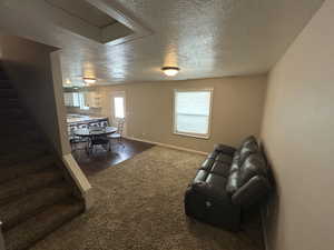 Living room with baseboards and a textured ceiling