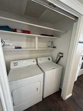 Laundry area featuring dark wood-style floors and independent washer and dryer