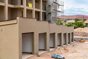 View of home's exterior with a mountain view and stucco siding