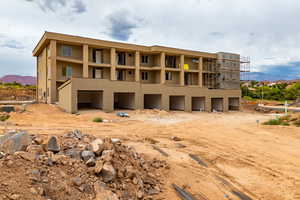 Rear view of house featuring a mountain view and stucco siding