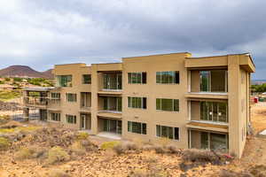 View of apartment building / complex featuring a mountain view
