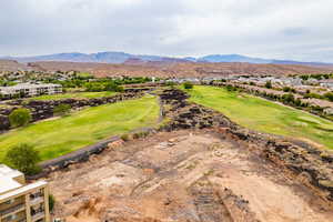View of mountain backdrop with a local golf course and nearby suburban area