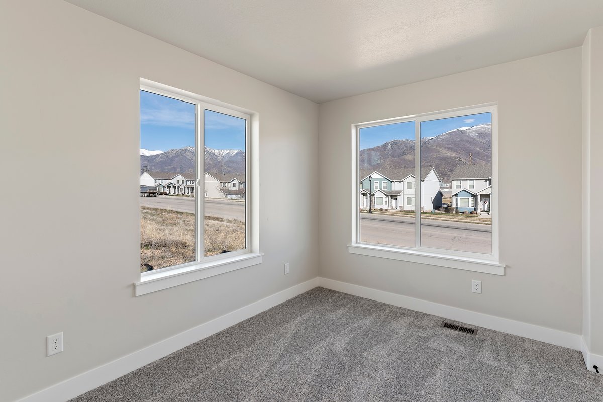 Carpeted empty room with a residential view and a mountain view