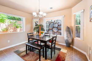 Dining room with suspended lighting and baseboards
