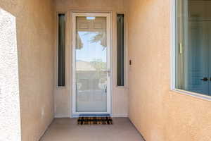 Entrance to property featuring stucco siding
