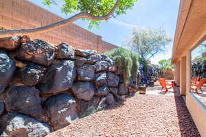 Exterior view of a fenced backyard and an outdoor fire pit